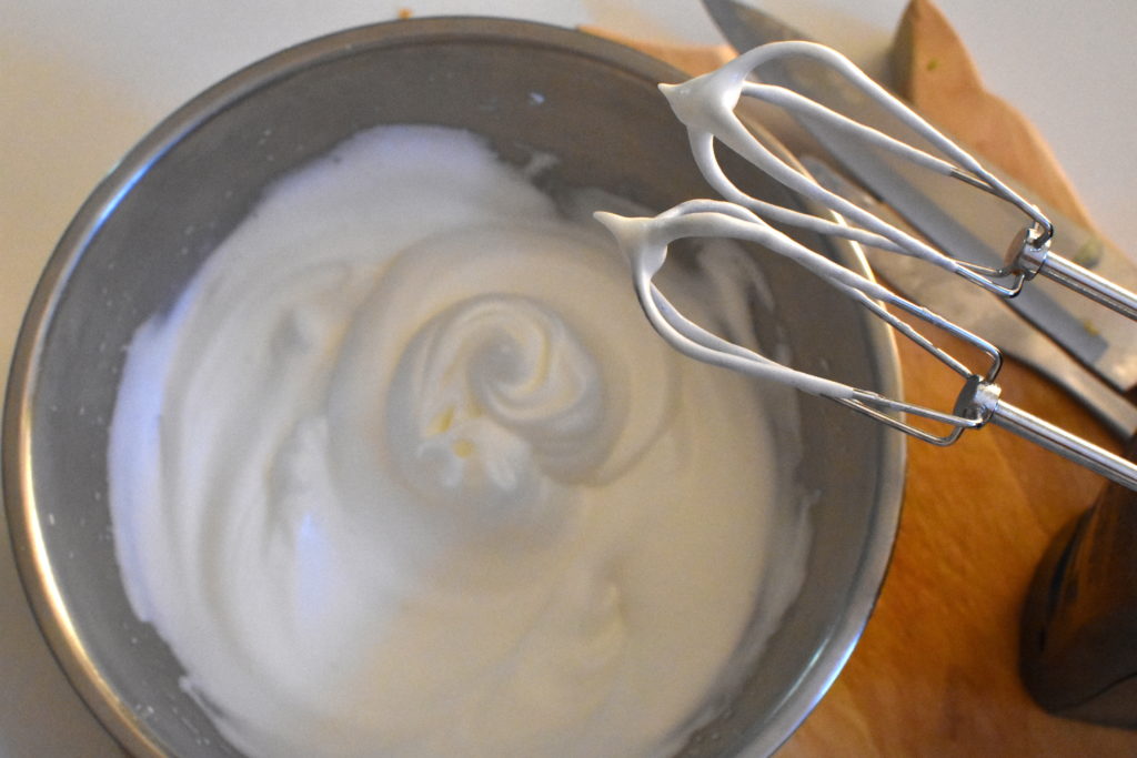 Whipped egg whites in metal bowl