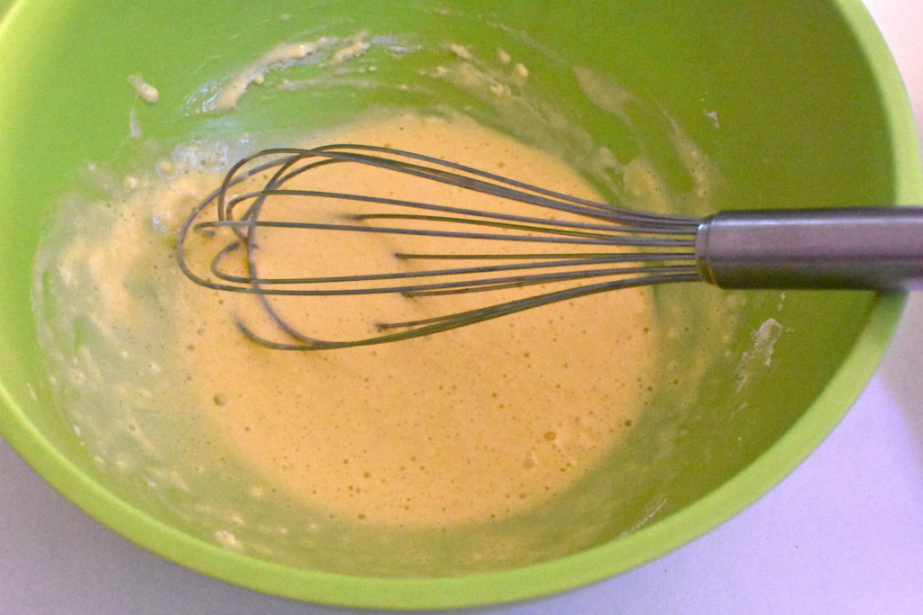 Mixing batter in green bowl