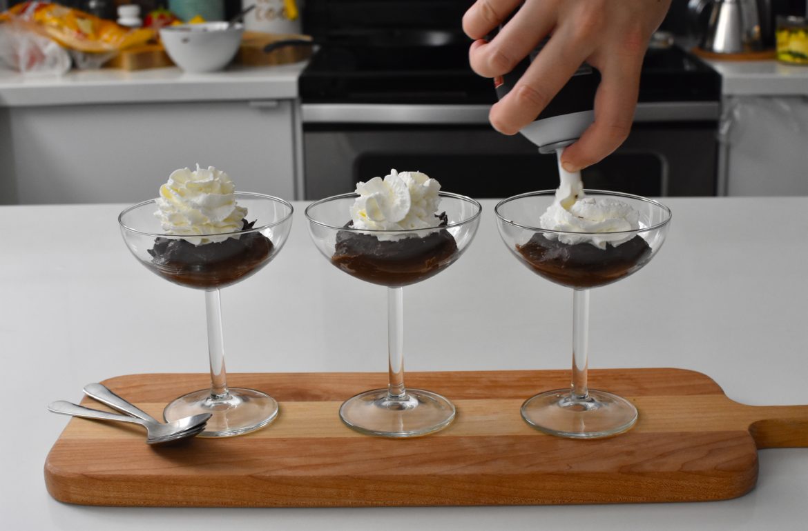 Chocolate pudding in a cup with whipped cream