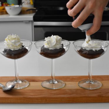 Chocolate pudding in a cup with whipped cream